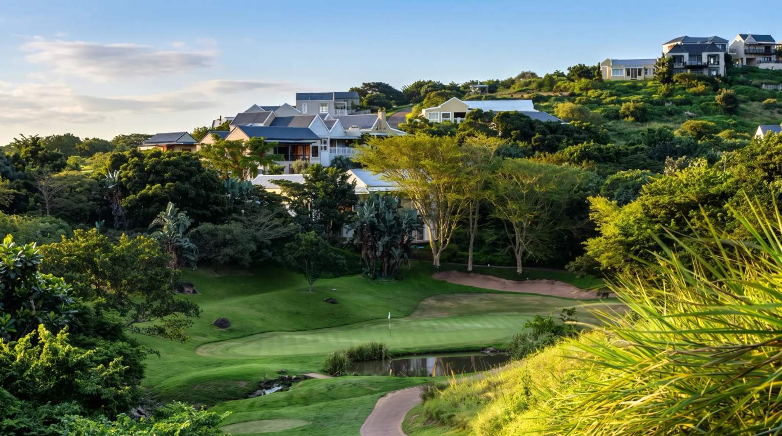 Prince's Grant Golf Estate with putting green and water feature, surrounded by homes amongst lush greenery.